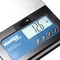 Digital shipping scale with a blue display showing weight, branded 'stamps.com'.